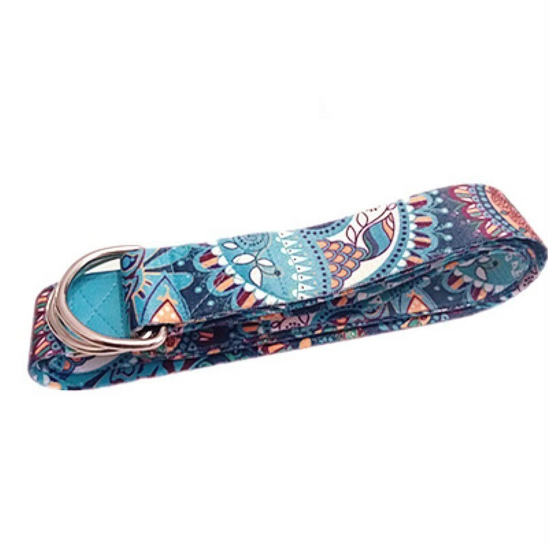 Printed yoga strap in teal and coral, looped through its metal D-ring buckle