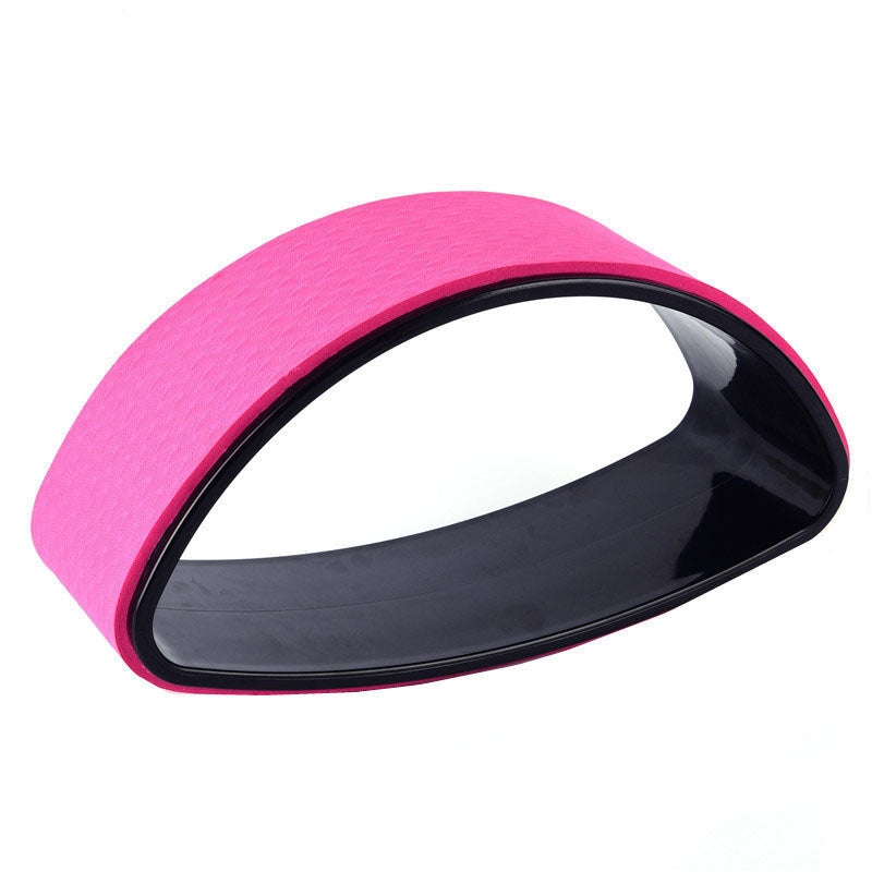 Pink half-moon yoga back trainer shown at an angle