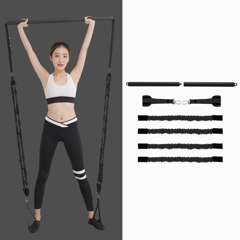 Woman holding a black Pilates bar overhead, beside the two-piece bar, foot straps and four resistance cords