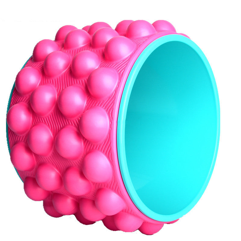 Pink spiky yoga wheel with a turquoise inner rim