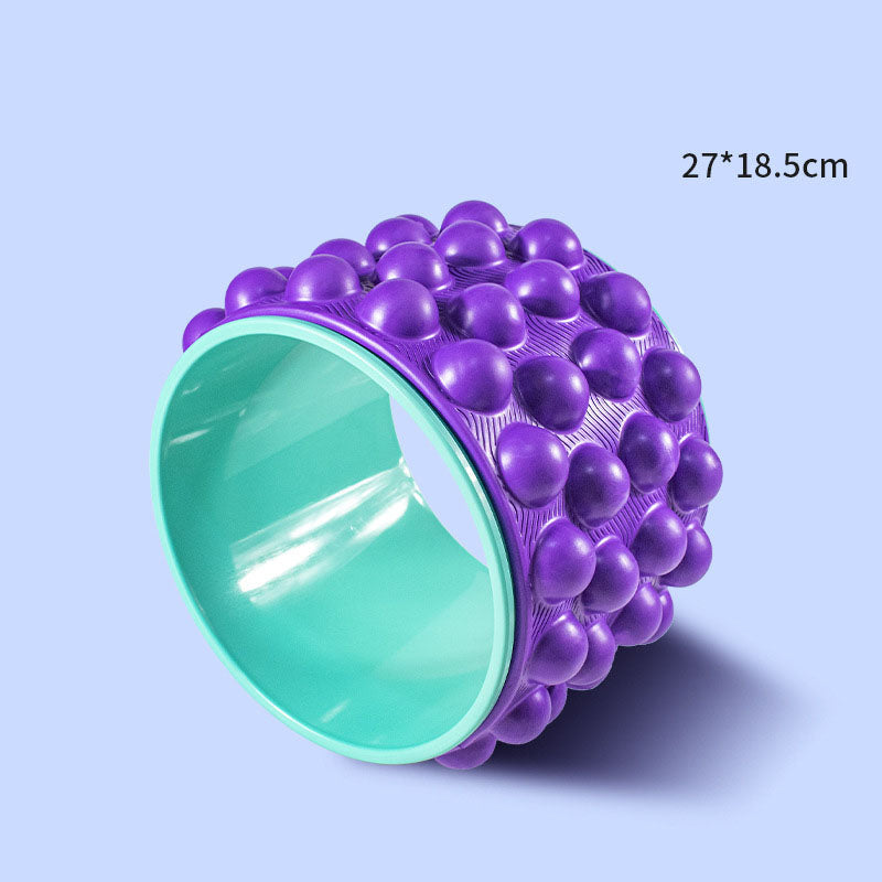 Purple spiky yoga wheel with a mint inner rim, sized 27 by 18.5 cm