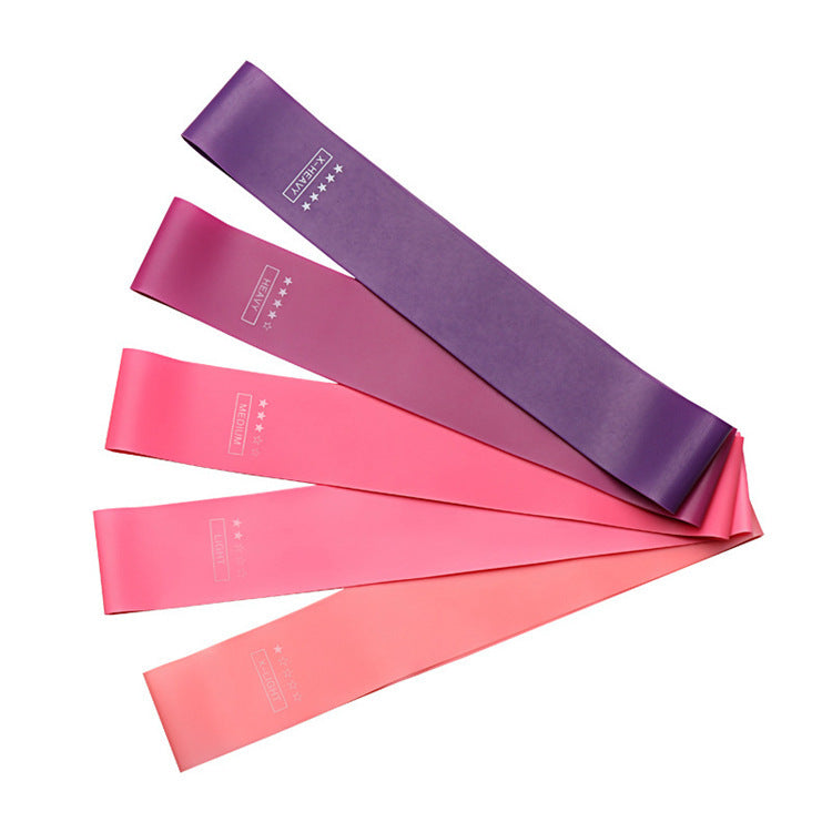 Set of five loop resistance bands fanned out, from purple to light pink