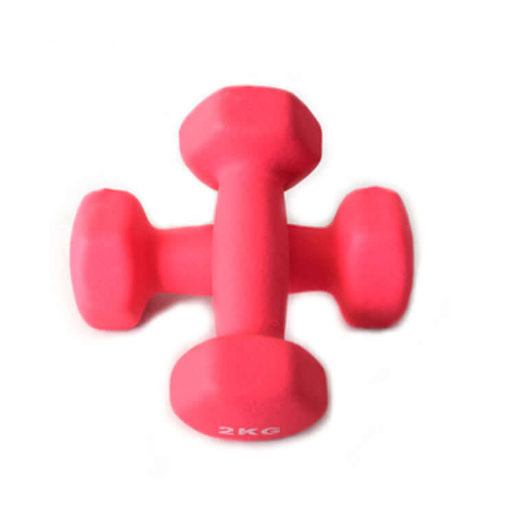 Two coral pink coated hex dumbbells crossed over each other