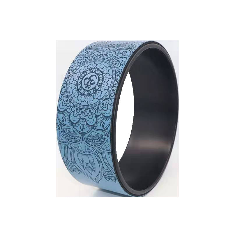 Blue yoga wheel with an embossed mandala and om pattern and a black inner rim