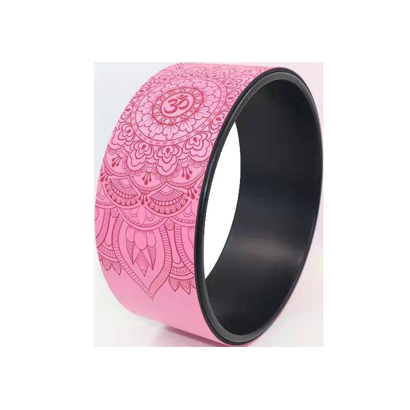 Pink yoga wheel with an embossed mandala and om pattern and a black inner rim