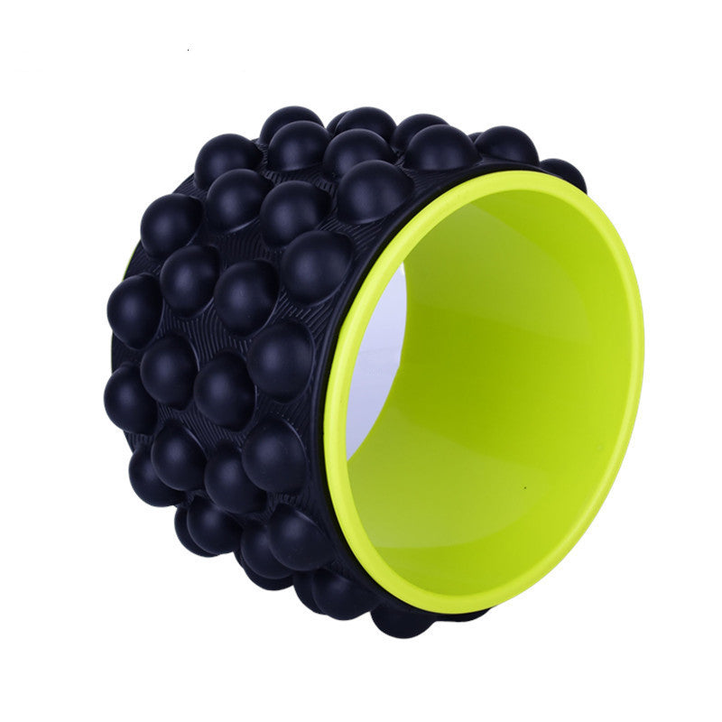 Black spiky yoga wheel with a lime green inner rim