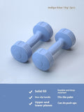 Pair of indigo blue 1 kg soft-touch dumbbells on a light blue background