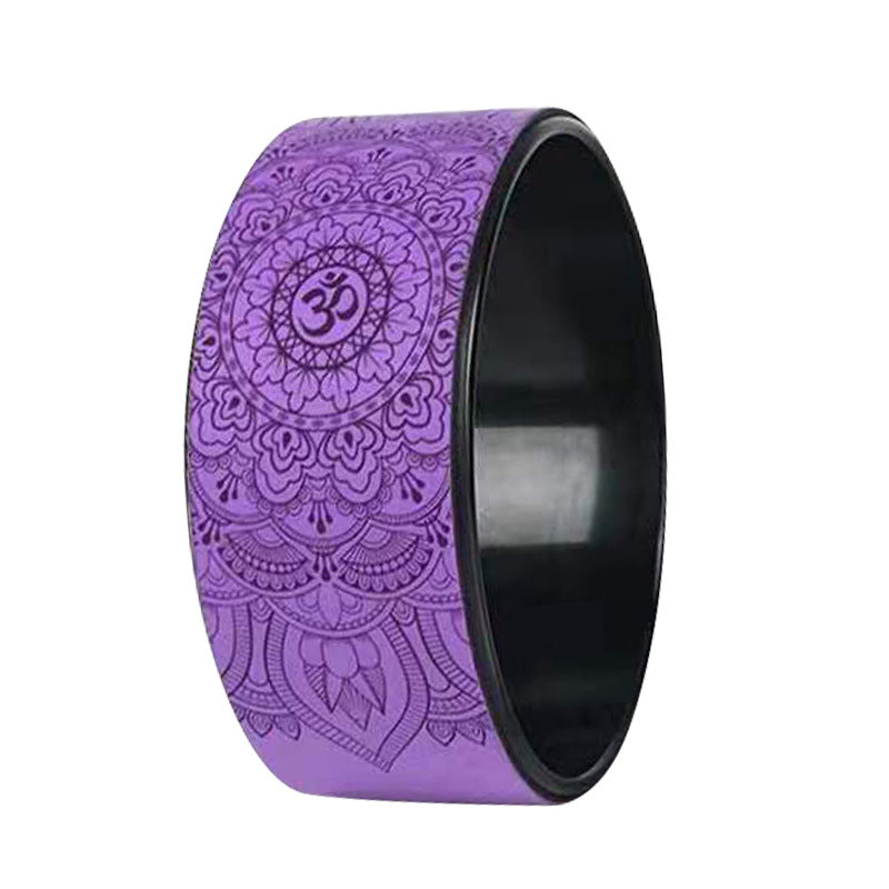 Purple yoga wheel with an embossed mandala and om pattern and a black inner rim