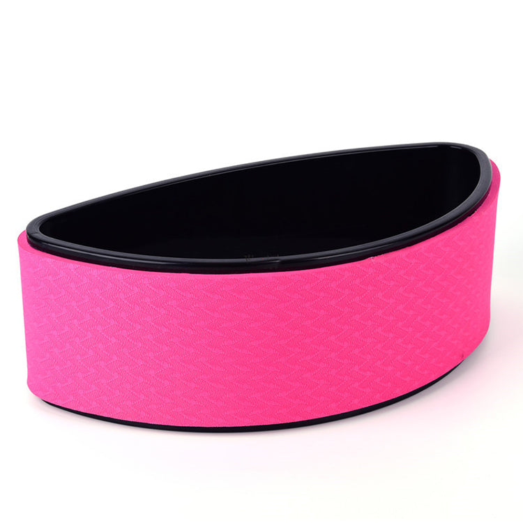 Pink half-moon yoga back trainer standing on its flat side