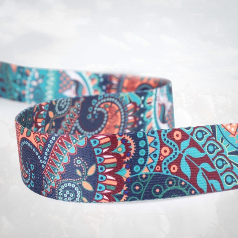 Close-up of the teal, navy and coral paisley print on the yoga strap