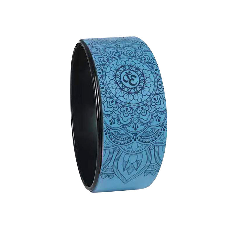 Blue yoga wheel with an embossed mandala and om pattern, seen from the side