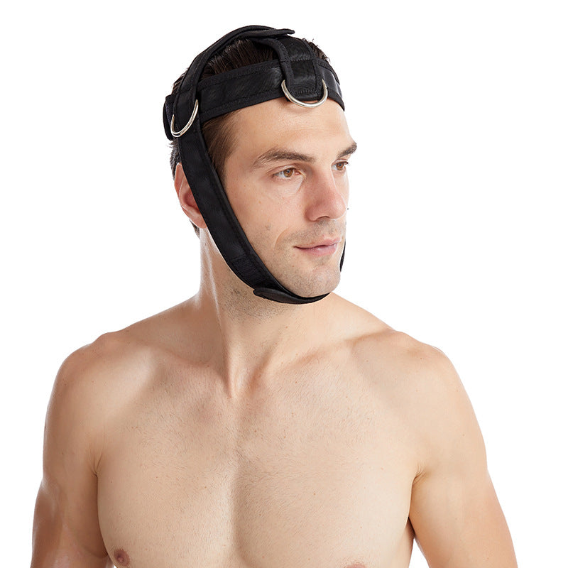 Man wearing a black neck training harness, looking to the side