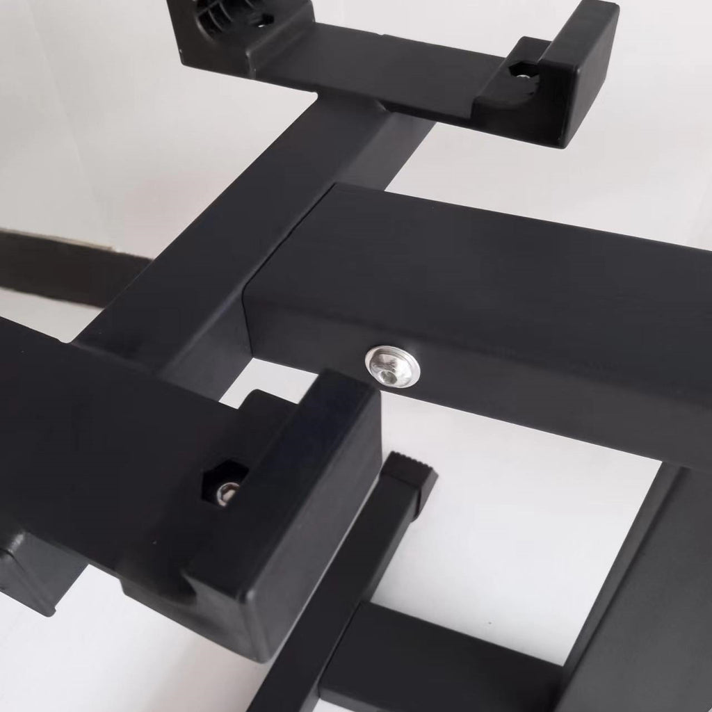 Close-up of the stand's dumbbell cradle and a bolt on the black steel frame