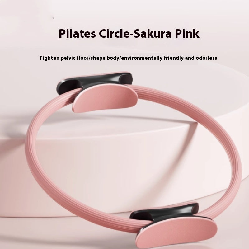 Pink Pilates ring with padded black and pink handles on each side