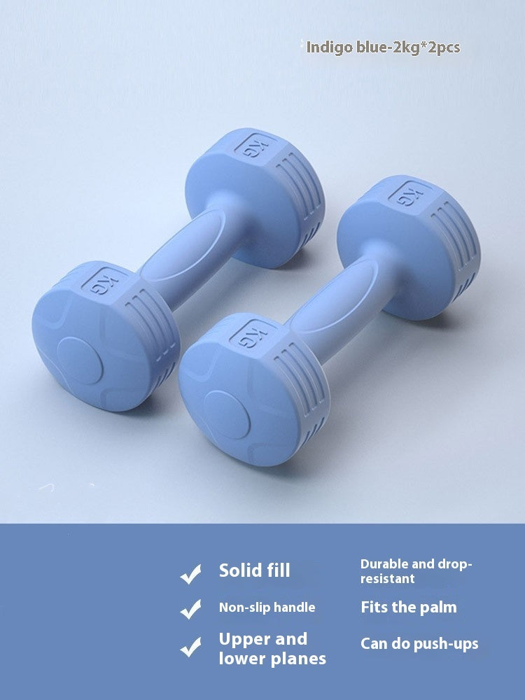 Pair of indigo blue 2 kg soft-touch dumbbells on a light blue background