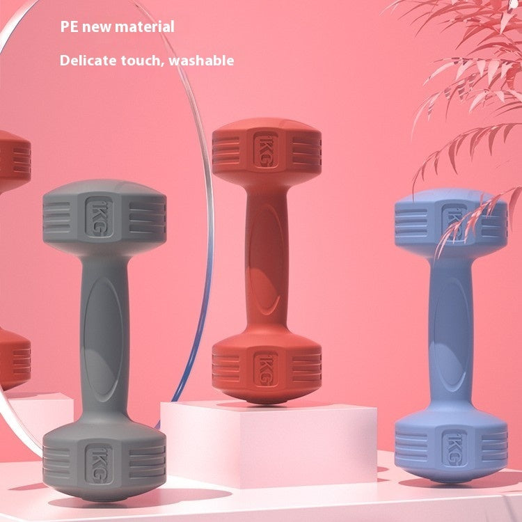 Grey, red and blue soft-touch dumbbells standing on display blocks