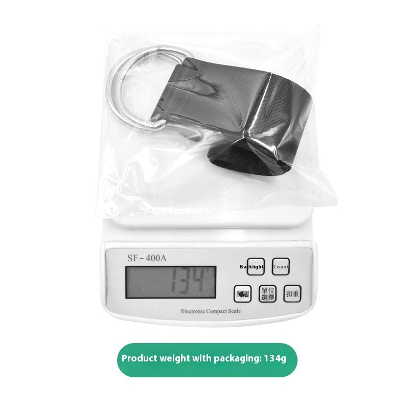 Black load belt in a clear plastic bag on a kitchen scale reading 134 g