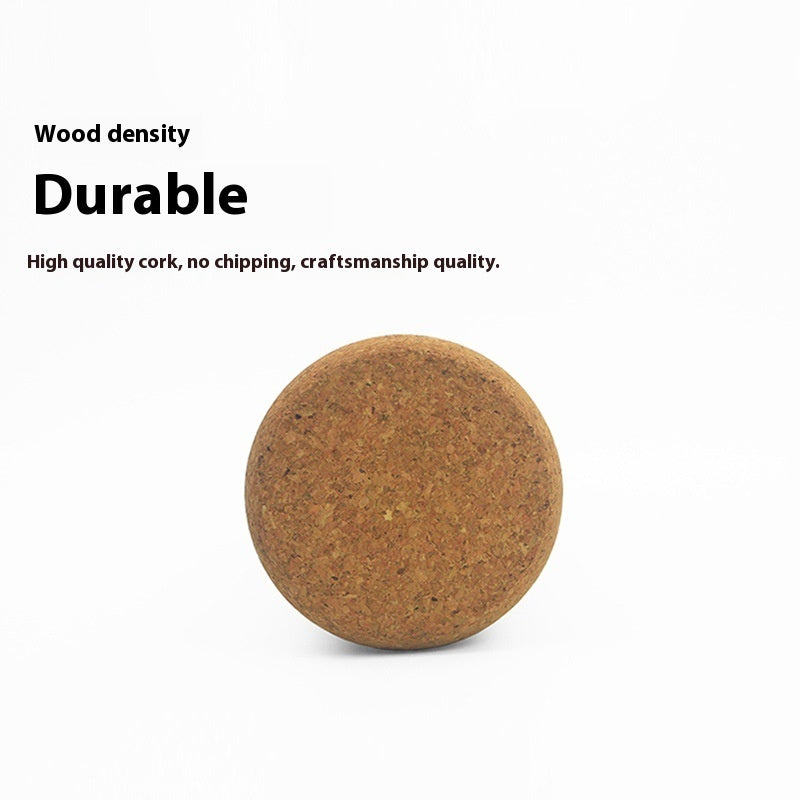 End view of a solid cork yoga roller showing its grain