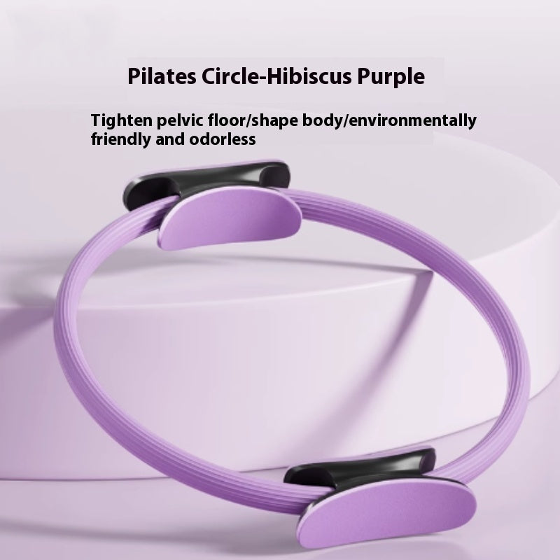 Purple Pilates ring with padded black and lilac handles on each side